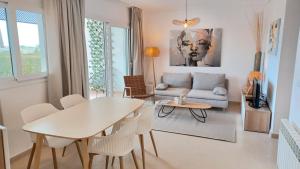 a living room with a table and a couch at Hacienda Riquelme Golf Resort Groundfloor Apartment 176 in Sucina