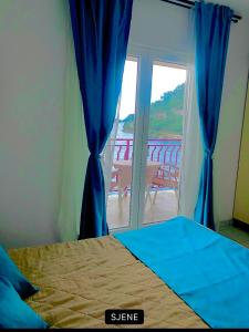 a bedroom with a bed and a sliding glass door at Villa Anita in Sobra