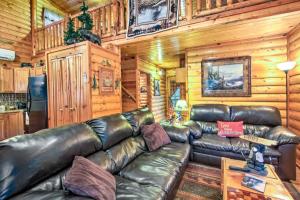 a leather couch in a living room in a cabin at Pet-Friendly Cosby Log Cabin with Backyard and Porch! in Cosby