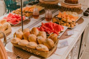a buffet filled with different types of sandwiches and fruit at Pousada Sette Mares in Fernando de Noronha