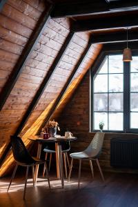 a dining room with a table and chairs in a attic at Voyager in Stepantsminda +14 photos