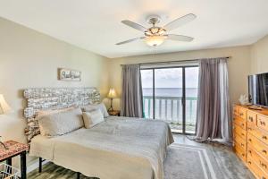 a bedroom with a bed and a large window at Waterfront Escape with Balcony on Shell Point Beach! in Panacea
