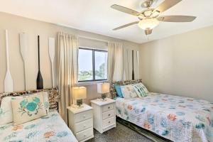 a bedroom with two beds and a ceiling fan at Waterfront Escape with Balcony on Shell Point Beach! in Panacea