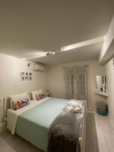 מיטה או מיטות בחדר ב-Piccolo Centrale