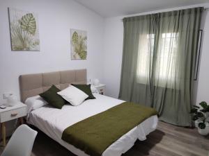 a bedroom with a large bed and a window at Rucanon 2 La casa del campo 4 Estrellas, Piscina y Golf in Montánchez +22 photos