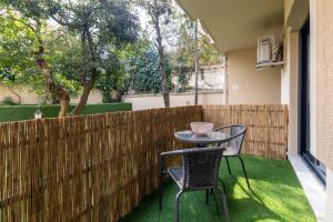 a patio with two chairs and a table and a fence at BayMari Suites Plus Florya in Istanbul