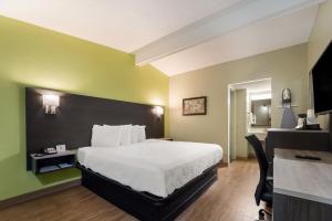 a hotel room with a bed and a desk at SureStay Hotel by Best Western Columbus Downtown in Columbus