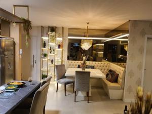 cocina y comedor con mesa y sillas en Apto de Luxo Mirante Home Club, Magnífico Mar dos Ingleses, en Florianópolis