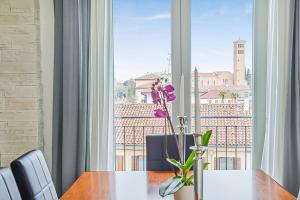 a dining room with a table and a large window at Elegant & Spacious - 30 min from Venice - King beds! in Treviso