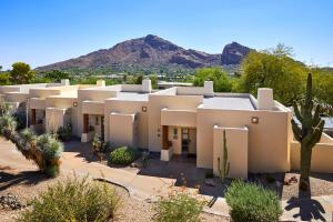 a building in the desert with a mountain in the background at JW Marriott Scottsdale Camelback Inn Resort & Spa in Scottsdale