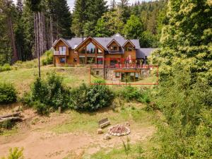 a large house on a hill in the woods at Santa Clara in San Carlos de Bariloche