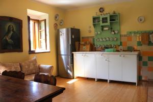 a kitchen with a refrigerator and a table in a room at Country house - Slapy/Pazderny in Žďár