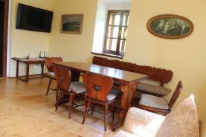 uma sala de jantar com uma mesa de madeira e cadeiras em Country house - Slapy/Pazderny em Žďár