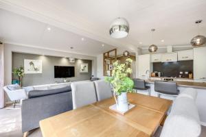 a dining room and living room with a table and chairs at Harrington in Narberth