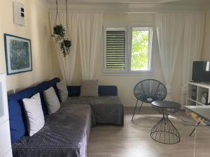 a living room with a couch and a table at Résidence Cala Montgo in L'Escala