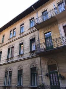 a tall building with windows and balconies on it at Csengery Apartment in Budapest
