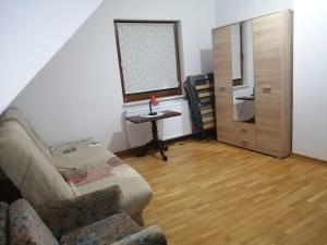 a living room with a couch and a table at holiday home, Kretowiny in Kretowiny