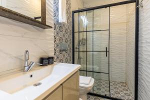 a bathroom with a toilet and a sink and a shower at BayMari Suites Plus Florya in Istanbul
