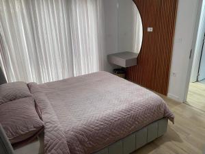 a bedroom with a bed and a sink next to a window at Bego Residence in Bitola