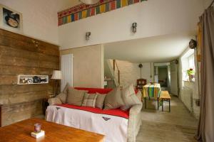 a living room with a couch and a table at Lower Godney Little House in Wells