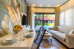 a living room with a table and a couch at BayMari Suites Plus Florya in Istanbul