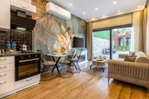 a kitchen and living room with a couch and a table at BayMari Suites Plus Florya in Istanbul
