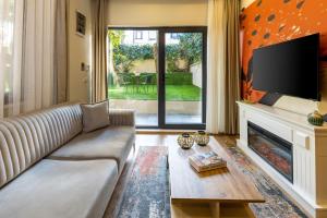 a living room with a couch and a fireplace at BayMari Suites Plus Florya in Istanbul +37 photos