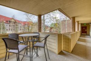 a balcony with chairs and a table and some windows at 2914 River Bank Lodge - Keystone in Keystone