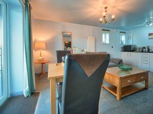 a living room with a table and a dining room at Tegid Lakeside - Bala Lake in Bala