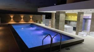 a large swimming pool in a building with at Brickell - APARMENT 3G amplio y elegante in Santa Cruz de la Sierra