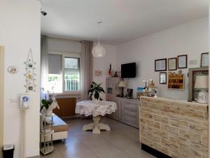 a living room with a table and a television at B&b villa lambusta in Cesenatico