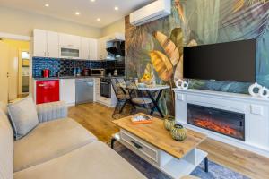 a living room with a fireplace and a flat screen tv at BayMari Suites Plus Florya in Istanbul