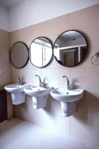 a bathroom with two sinks and two mirrors at Ramallah Hostel in Ramallah