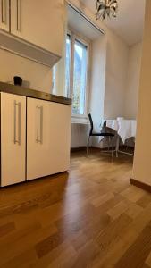 a kitchen with white cabinets and a dining table at Eigenes Studio (Apartment) in Biel