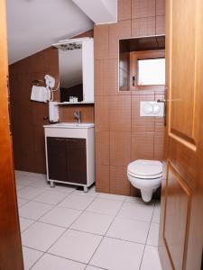 a bathroom with a toilet and a sink at Stara Ada Banja Luka in Banja Luka