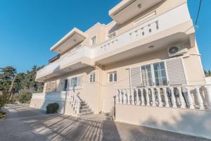 a large white building with a balcony at Dion House in Psalidi