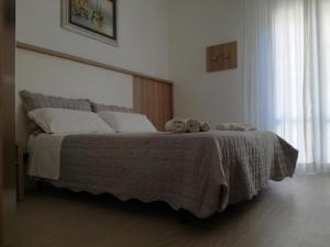 a bedroom with a bed with two stuffed animals on it at B&b villa lambusta in Cesenatico