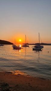 a group of boats in the water at sunset at Emerald Beloc House Lopud Island in Lopud