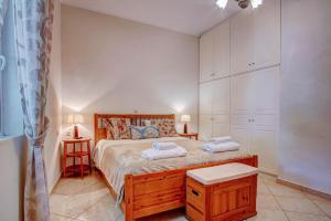 a bedroom with a bed with two towels on it at The Love Villa in Kassiopi +198 photos