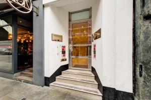 a store front with a glass door on a building at Apartment in the heart of London in London