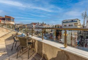 a balcony with a table and chairs and a view of a city at BayMari Suites Plus Florya in Istanbul