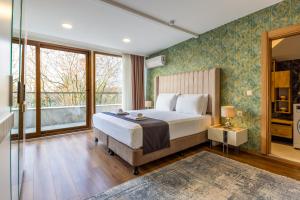 a bedroom with a bed and a large window at BayMari Suites Plus Florya in Istanbul