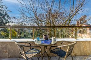 a table and two chairs on a balcony with a view at BayMari Suites Plus Florya in Istanbul