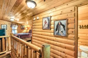 a log cabin bathroom with a toilet and pictures on the wall at Smoky Mountain Rustic Log Cabin with Furnished Patio in Cosby