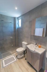 a bathroom with a toilet and a sink and a shower at Kos Helios House in Psalidi