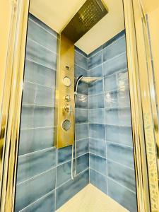 prysznic z niebieskimi płytkami w łazience w obiekcie San Gregorio Luxury Apartments w mieście Napoli