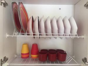 a shelf with plates and bowls in a refrigerator at Finca en Cimarrones, Chachagui - Fundadores in Chachagüí