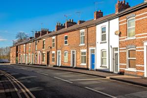 a row of brick houses on a street at Southview Stays - Three bedroom House in Chester