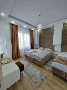 a bedroom with two beds and a couch at Long beach luxury Premium apartments in Ulcinj
