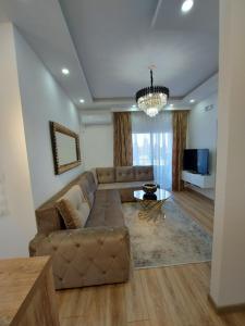 a living room with a couch and a table at Long beach luxury Premium apartments in Ulcinj